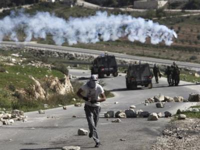 Palestinos corren para ponerse a salvo de las bombas lacrimgenos lanzadas por soldados israeles, durante un enfrentamiento al trmino de las oraciones del Viernes, en Nabi Sal, Cisjordania, hoy, viernes, 9 de marzo de 2012. Los palestinos protestaban contra la expansin del asentamiento israel de Halamesh. EFE